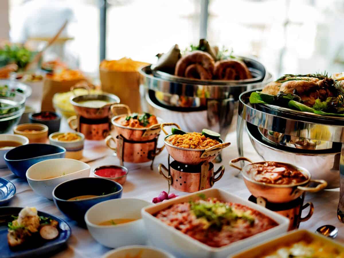 A close up of a catering setup with both hot and cold plates