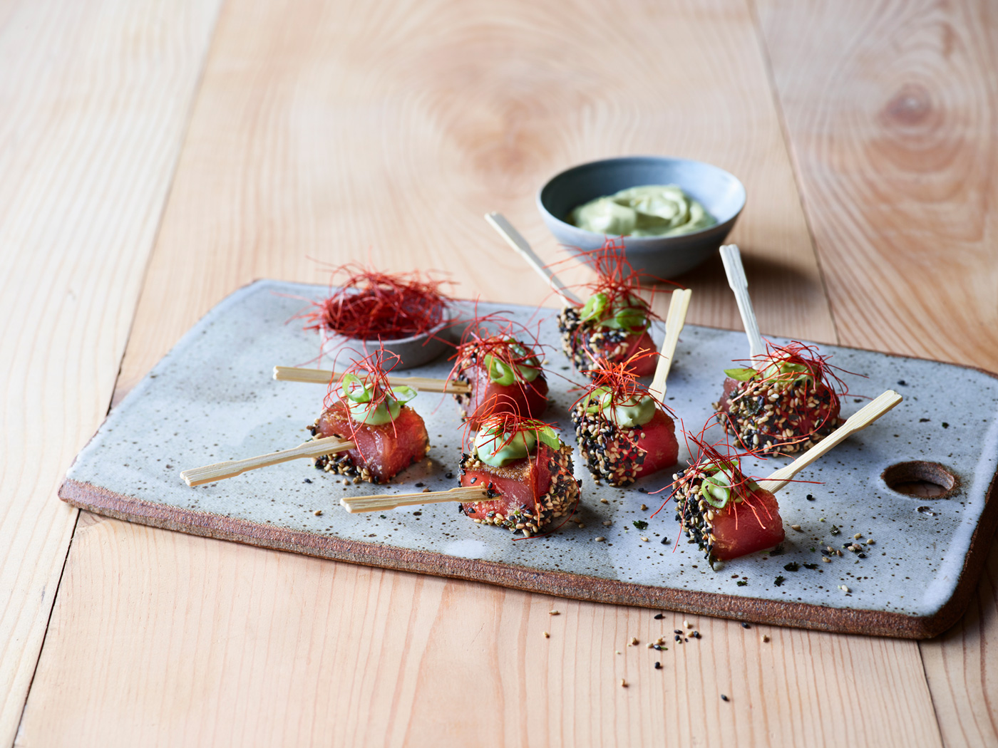 Poke skewers on a ceramic serving surface