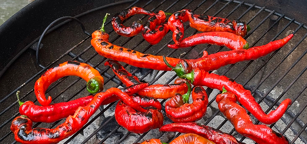 Jimmy Nardello Peppers Charring On An Outdoor Grill