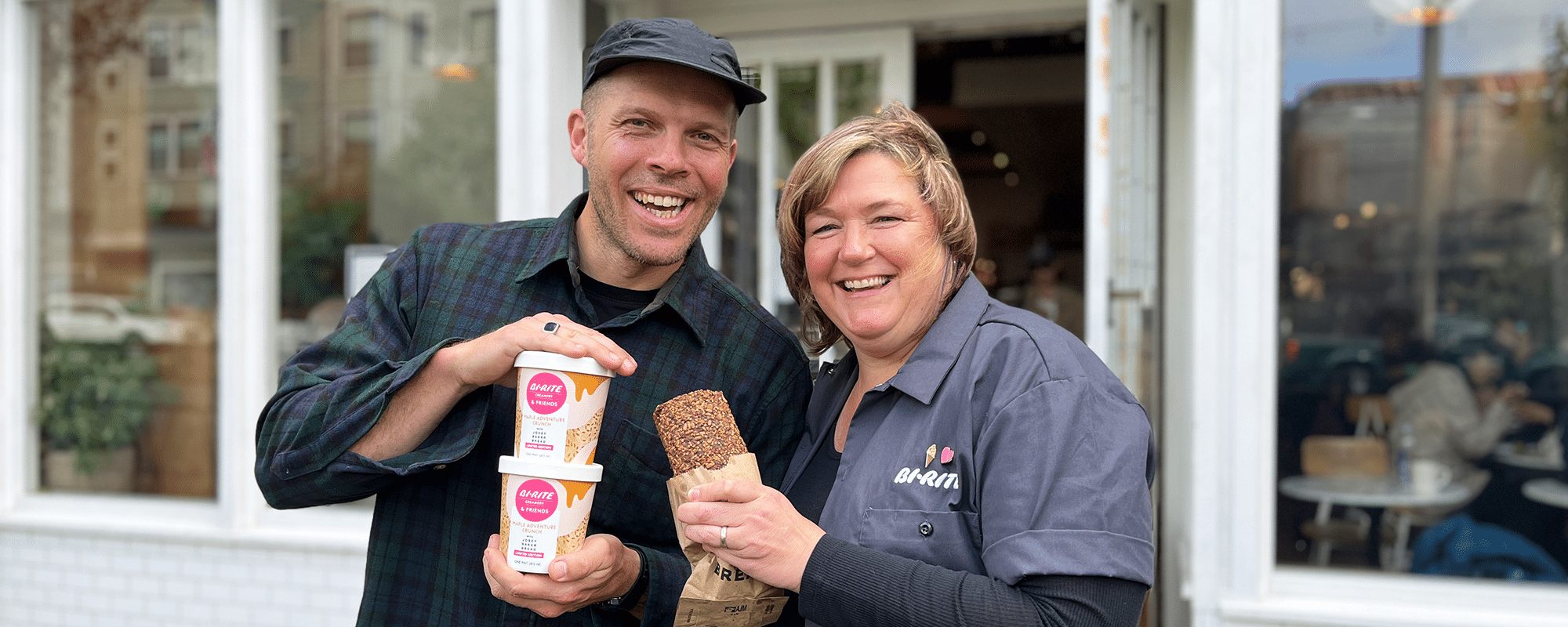 Josey And Kris Outside Of The Mill Holding Pints And Adventure Bread