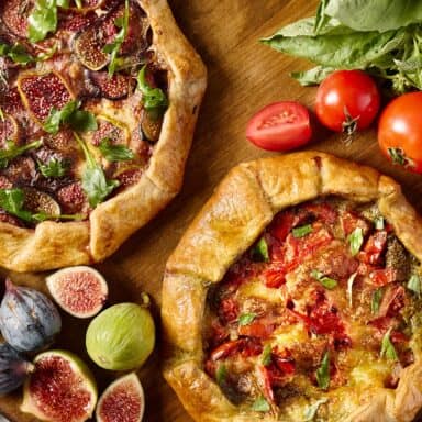 Two Galettes Surrounded By Ingredients On Wood
